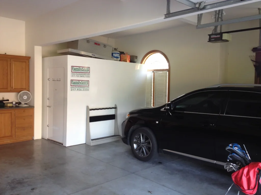 Large white safe and black SUV in garage