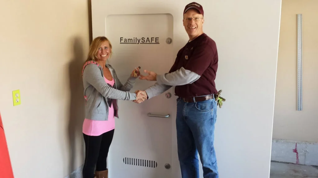 Woman receives keys in front of large safe