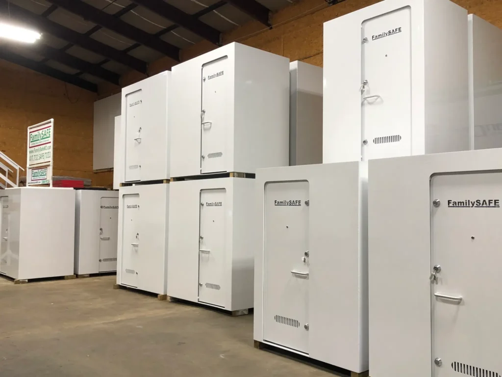Stacked white FamilySAFE storm shelters in warehouse