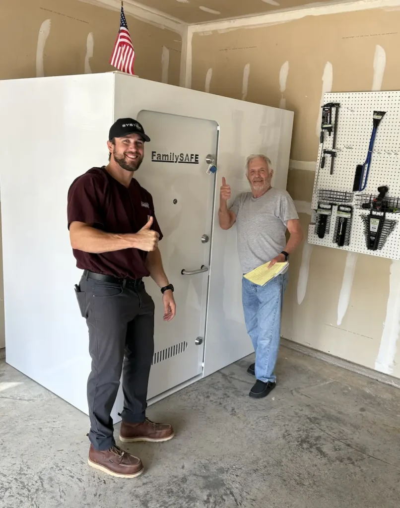 Two men beside large FamilySAFE safe in garage