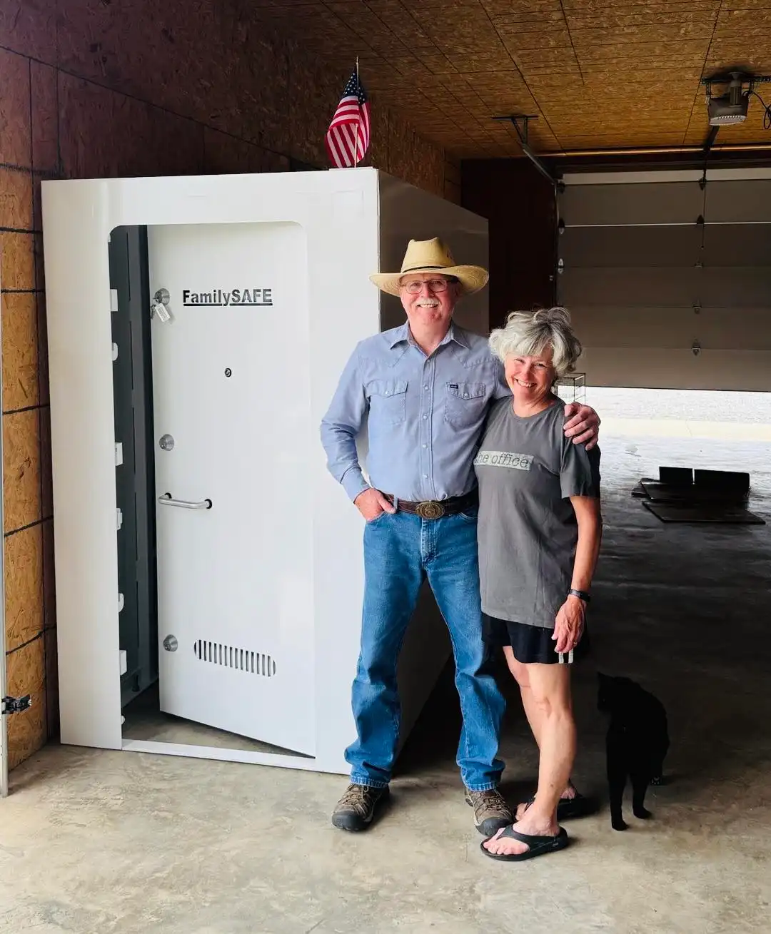 Couple poses by storm shelter with cat
