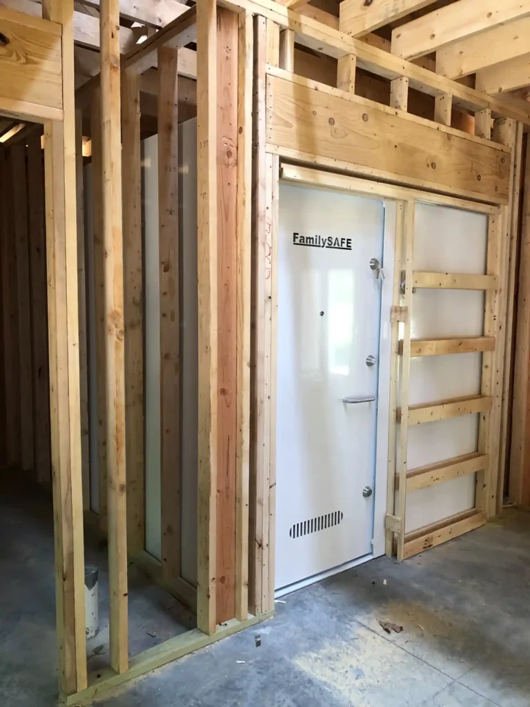 Steel safe room door inside wood framing