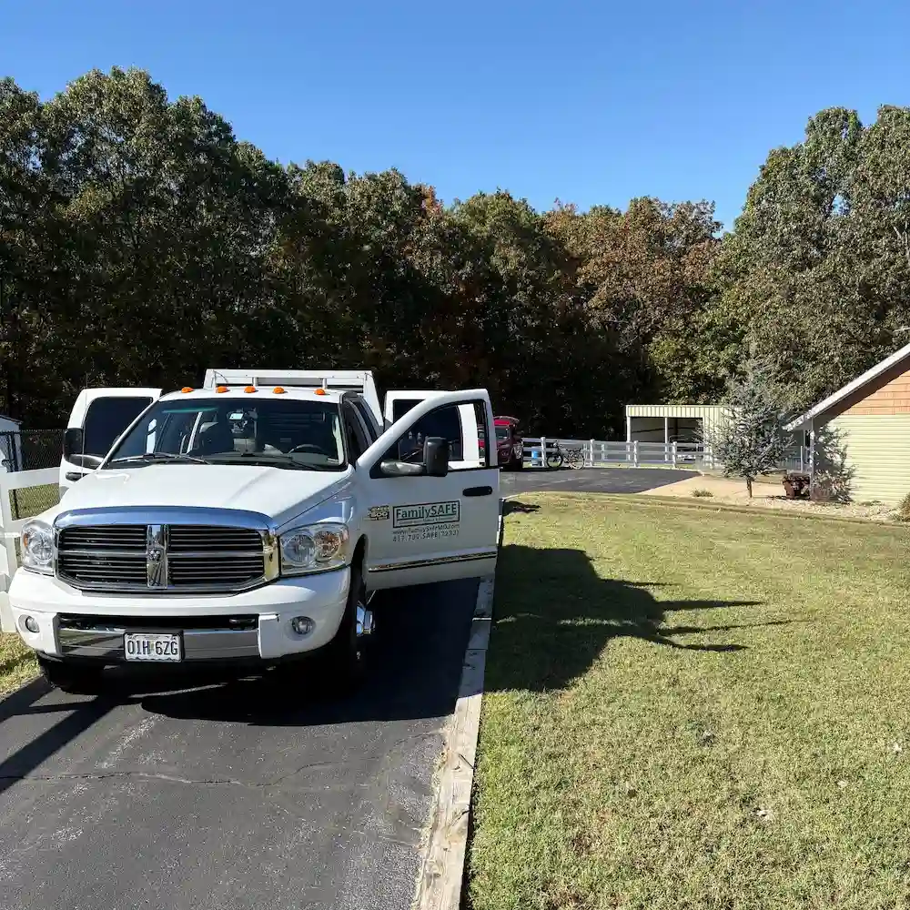 White service truck parked in suburban driveway