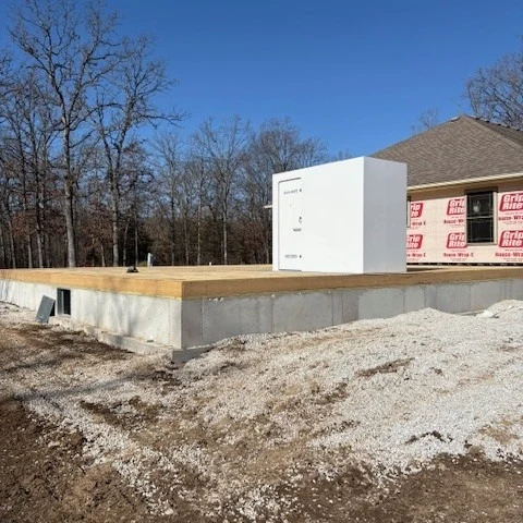 New home foundation with wooden subfloor and white cube
