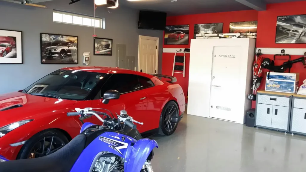 Red sports car and blue dirt bike in garage