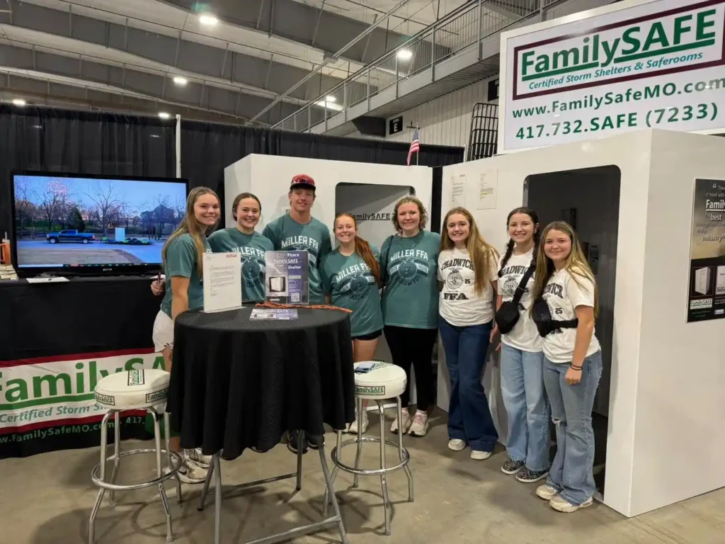 Group showcasing storm shelters at an expo