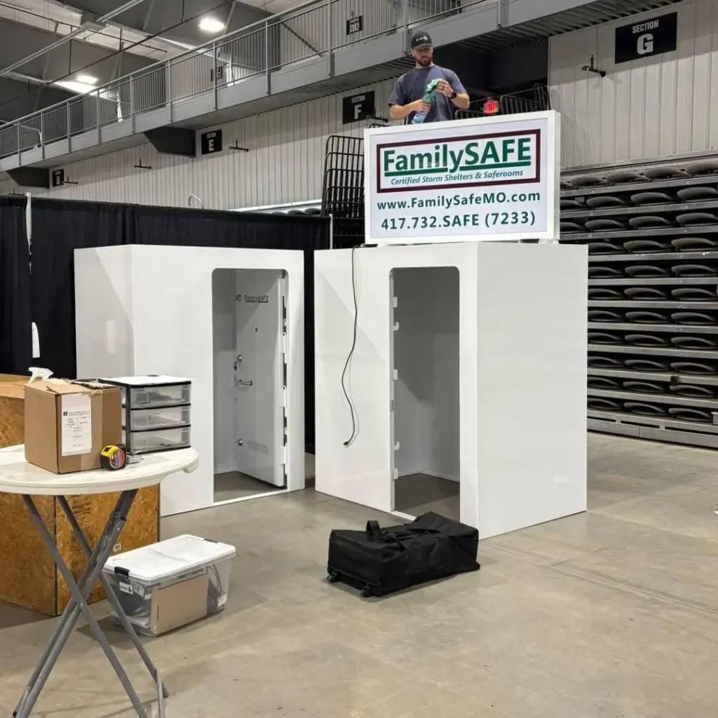 Man assembling storm shelter display