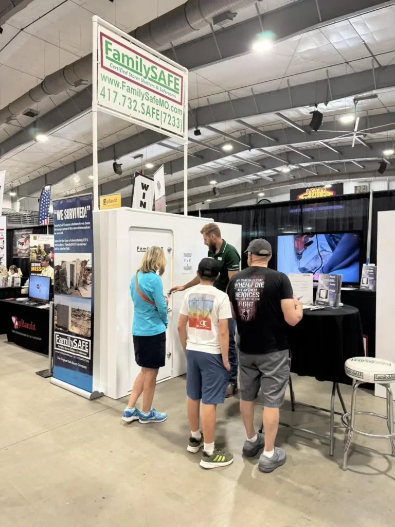 People observing a FamilySAFE storm shelter exhibit.