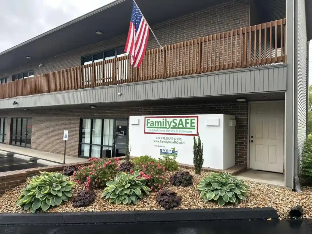 Two-story building with American flag outside.