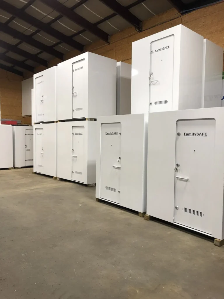 White storm shelters stacked in a warehouse