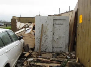 Storm debris and damaged buildings with overturned safe
