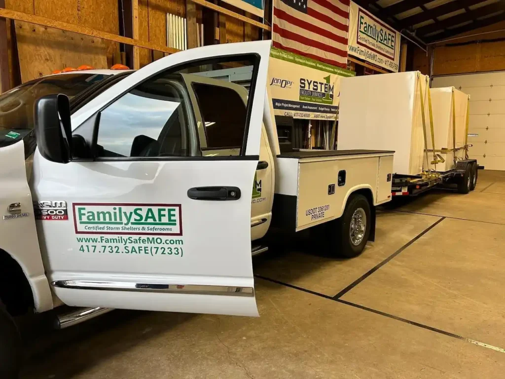 Truck with storm shelter trailer in warehouse