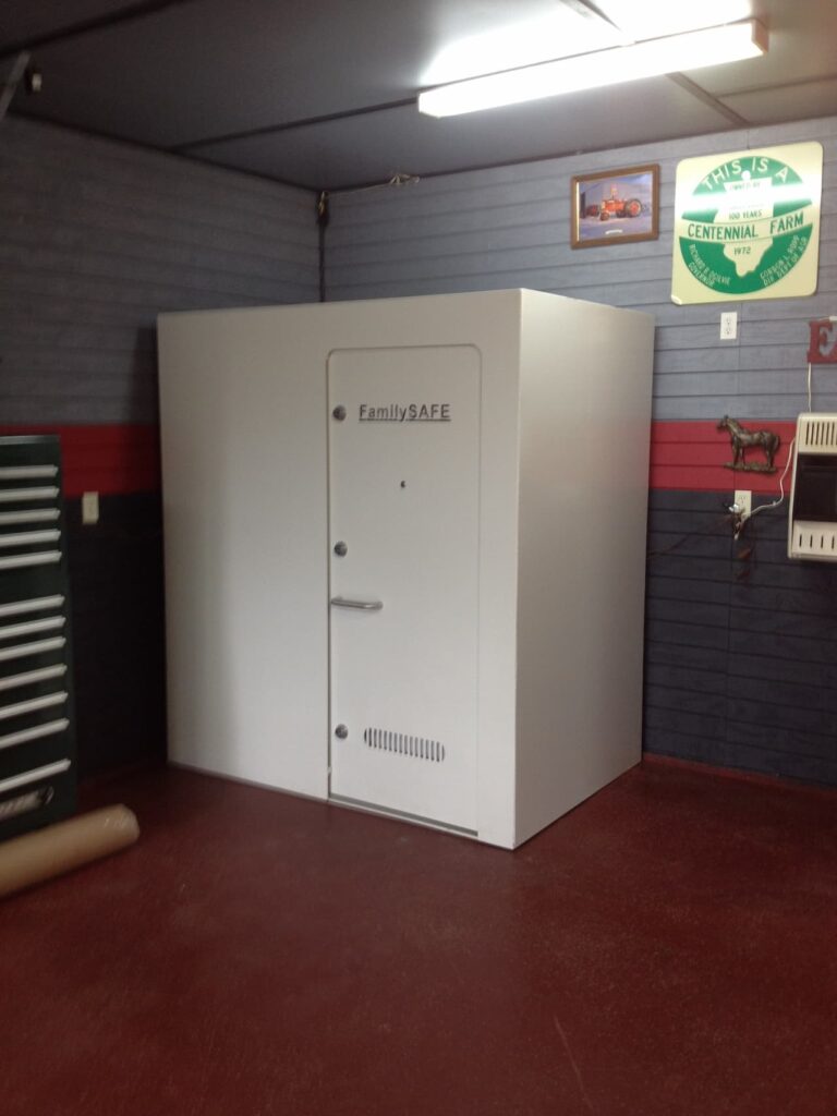 Large white FamilySAFE storm shelter in garage