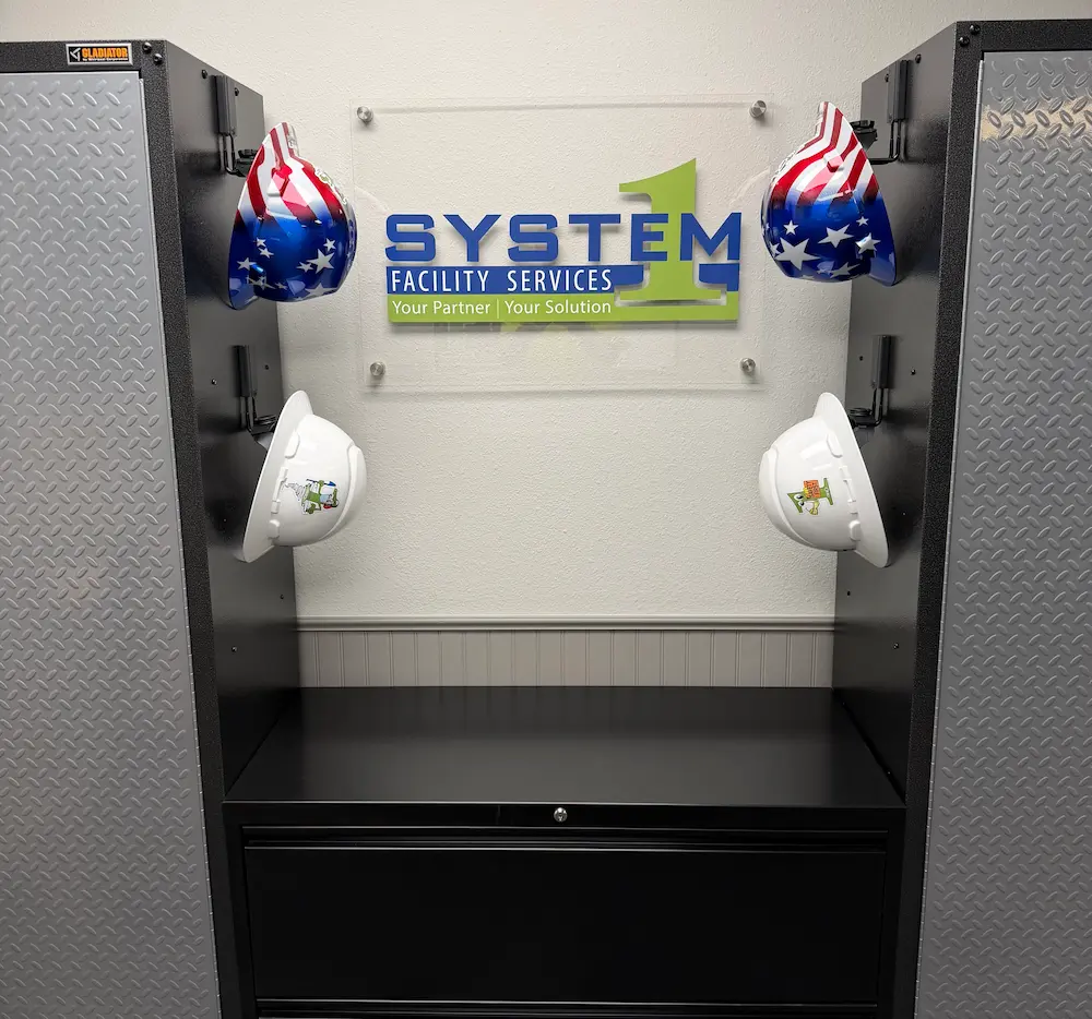 Industrial cabinets with mounted hard hats and company sign