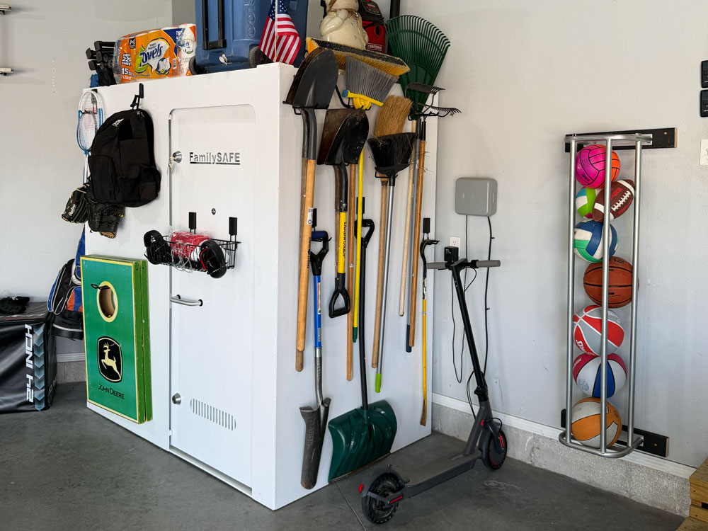 Organized garage with tools, safe, and sports balls