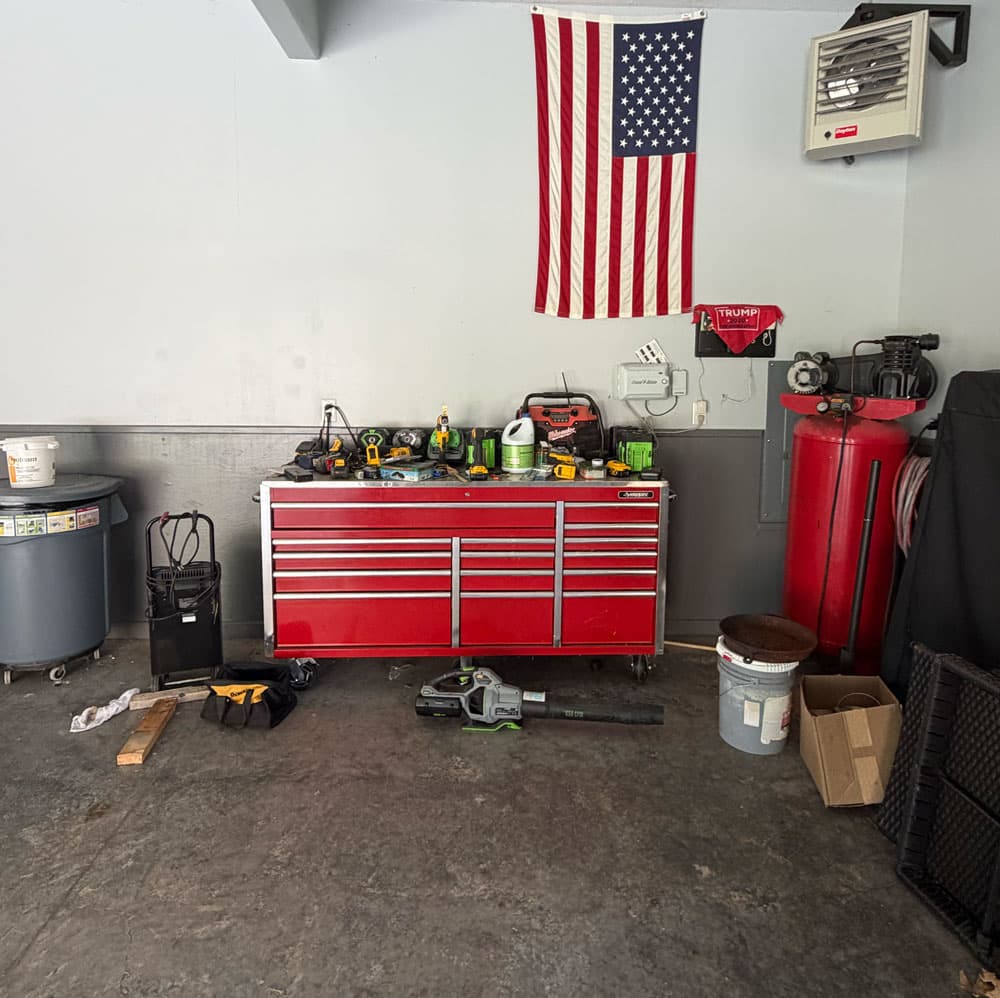 Garage workspace with red tool chest and American flag