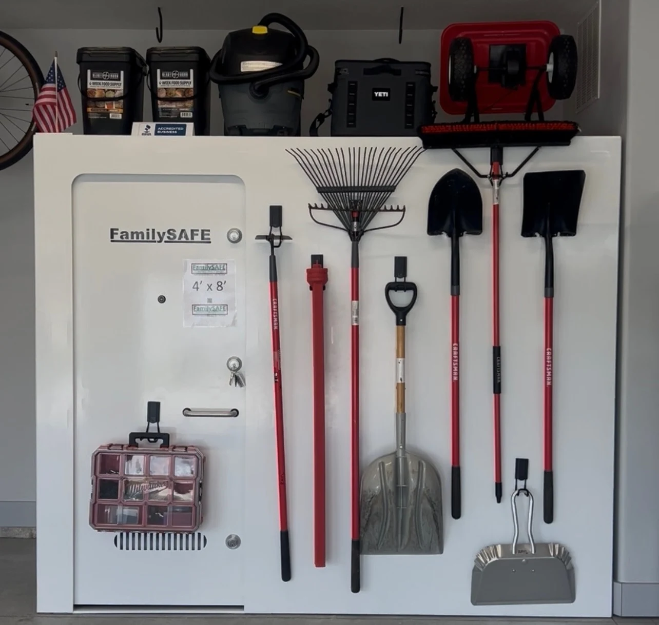 Organized garage wall with storm shelter and tools