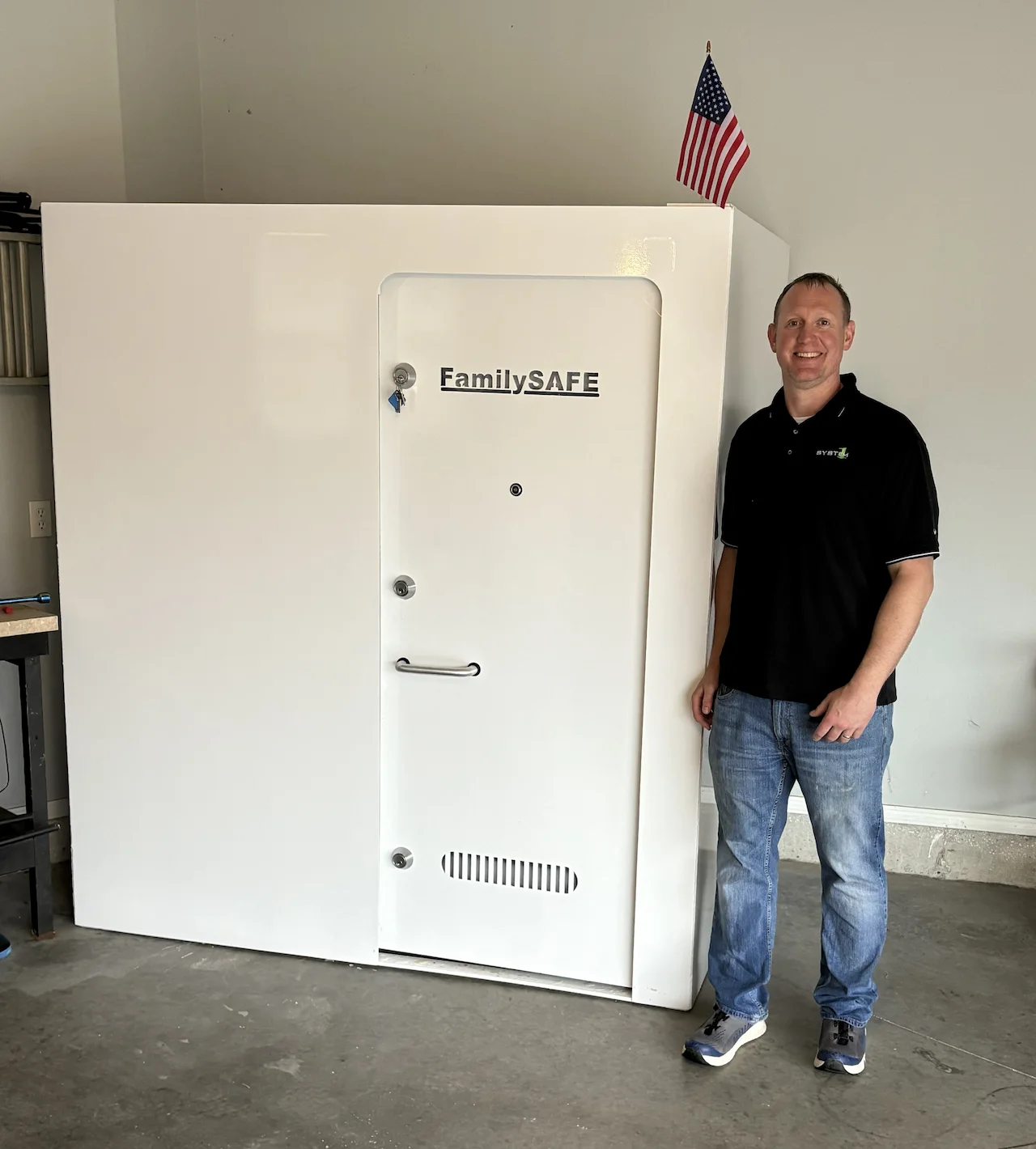 Man standing beside large FamilySAFE storm shelter